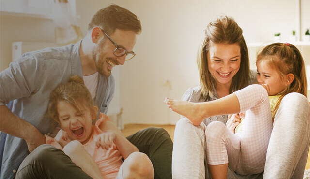 Familie tobt auf dem Sofa